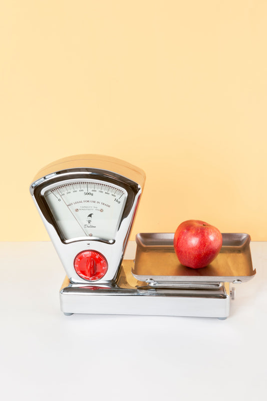 Scale with an apple on it